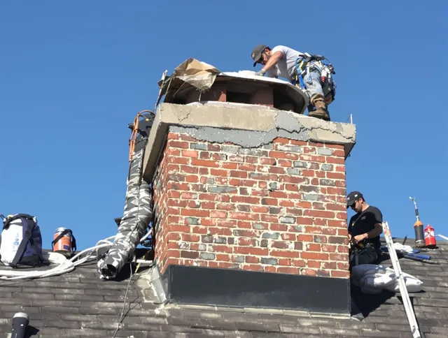 Medway Chimney Sweep installing a custom chimney crown in Medway, MA